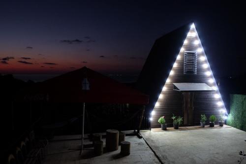a church at night with a lit up building at MamukaHouse in Tsikhisdziri