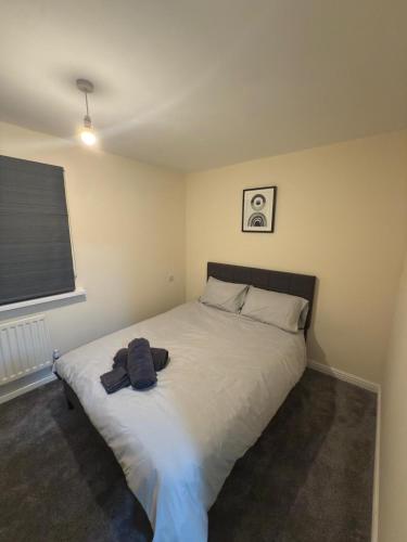 a bedroom with a bed with two towels on it at Luxury 2-Bedroom Home 10 Minutes from Birmingham City Centre in Birmingham