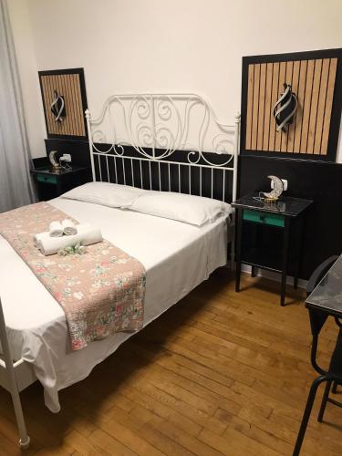 a bedroom with a bed and two tables with towels at Roberta in Bologna