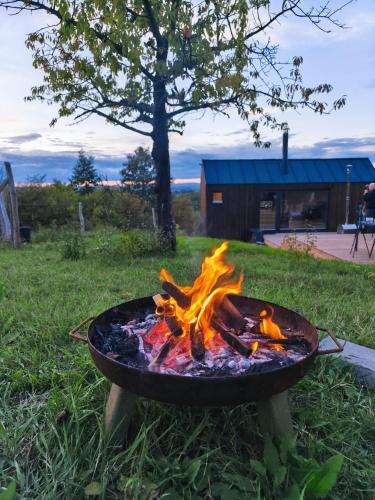 a fire pit in the grass in a yard at NestOff in Romhány