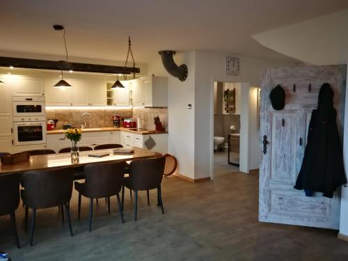 a kitchen and dining room with a table and chairs at Boddenkutter in Born