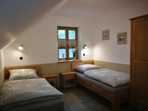 a bedroom with two beds and a window at Boddenkutter in Born