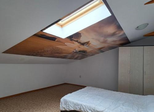 een slaapkamer met een plafond met een schilderij op het plafond bij LCB Apartments Braşov in Braşov
