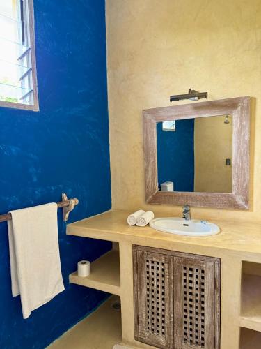 a bathroom with a sink and a mirror at Seaside Villa 1 & Seaside Villa 2 at 'Tamani' in Diani Beach