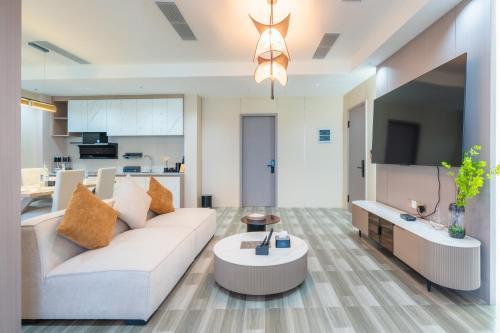 a living room with a couch and a table at Wings by Hawks Hotels Kamadhoo Baa Atoll in Kamadhoo