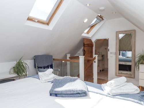 a bedroom with a bed and a chair and a mirror at The Workshop in Tavistock