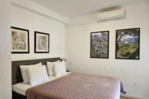a bedroom with a bed and three pictures on the wall at Casa La Vall in Beniali