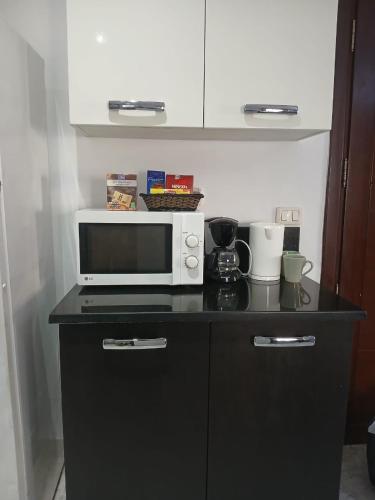 a microwave sitting on top of a counter at Locationsecurity in Tunis