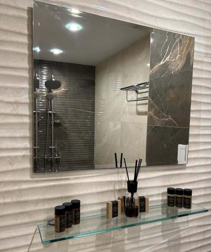 a glass shelf in a bathroom with a mirror at Zlati`s house 1 in Sofia