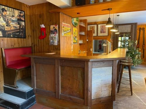 a kitchen with a wooden counter with a red chair at Essener Skihütte in Willingen