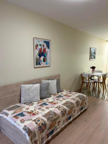 a bedroom with a bed and a table at Zlati`s house 1 in Sofia