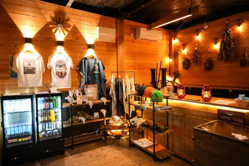 a room with a store with a counter and a refrigerator at From P in Hakuba