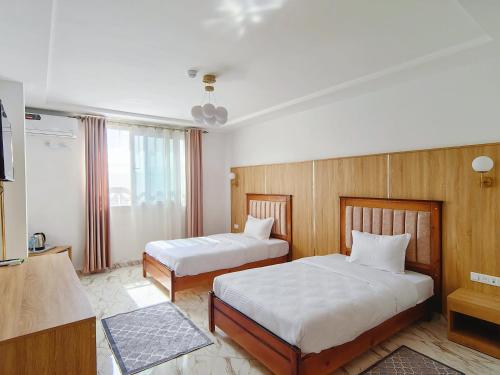 Una cama o camas en una habitación de Hotel Al Zahra