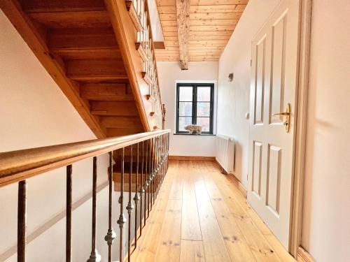 a staircase in a house with wooden ceilings at Villa Nikolaj - Historisches Pastorat in Fehmarn