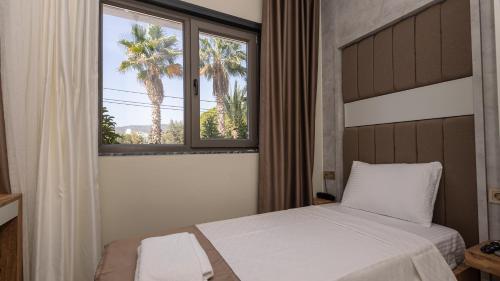Ένα ή περισσότερα κρεβάτια σε δωμάτιο στο Holmi Otel
