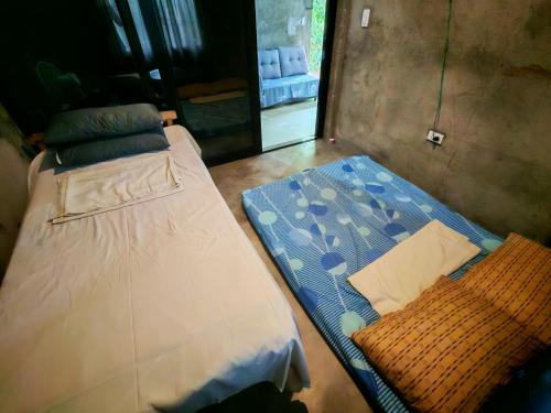 a couple of beds sitting in a room at Belmoro Transient House in Bacacay