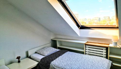 a small bedroom with a bed and a window at Green Wood Apartament Stara Ochota in Warsaw