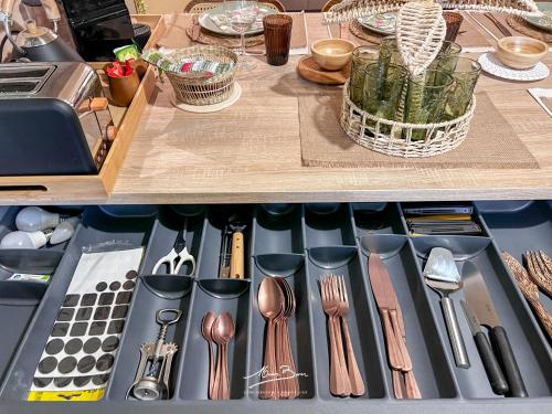 a drawer filled with kitchen utensils on a table at Appartement de Standing Bali 2 Chambres, Terrasse, Wifi, Hyper-Centre Toulon in Toulon