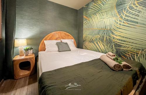 a small bedroom with a bed with a tropical mural at Appartement de Standing Bali 2 Chambres, Terrasse, Wifi, Hyper-Centre Toulon in Toulon