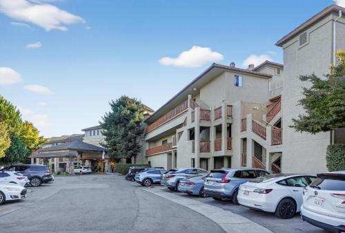a row of cars parked in a parking lot next to buildings at Luxury Ocean View Condo - Heated pool and Spa condo in La Selva Beach