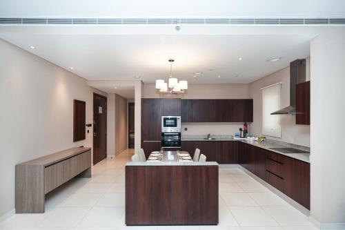 a kitchen with a island in the middle at Eden Garden Hotel Apartment in Manama