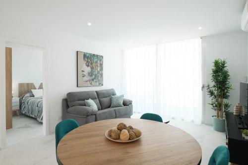 a living room with a table and a couch at Isla Bonita Blik by Huskalia in Puerto Naos