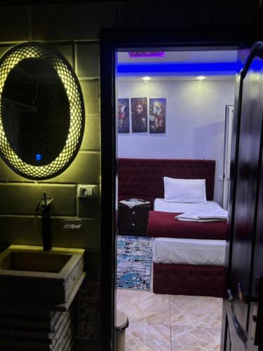 a room with a bed and a mirror and a sink at Rost pyramids view in Cairo