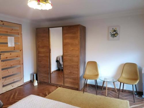 a bedroom with a large mirror and two chairs at Magnolia in Sobolew