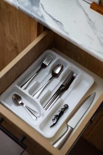 a white tray with silver utensils on a table at Apartment KeyGo #0191 comfort and coziness in the city in Yerevan