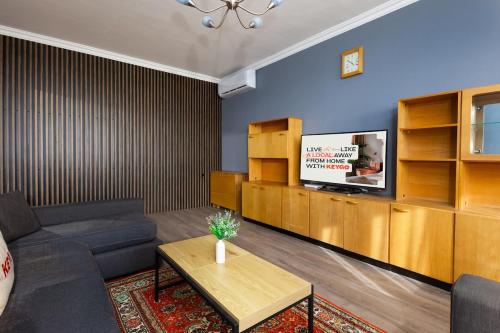 a living room with a couch and a tv at Apartment KeyGo #0191 comfort and coziness in the city in Yerevan