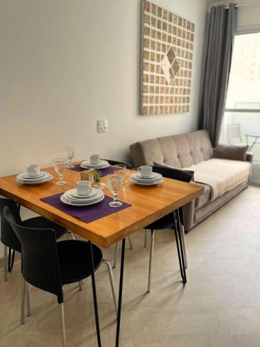 a dining room table and chairs in a living room at LK Centro 1 in Belo Horizonte