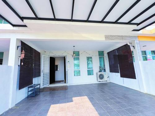 a white building with awning and a patio at Bangi Avenue, 43000 Kajang Fully Air-Con Homestay in Kajang