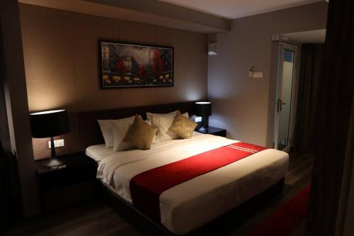 a bedroom with a bed with a red and white blanket at Urbano Luxury Homestay at Maritime in George Town