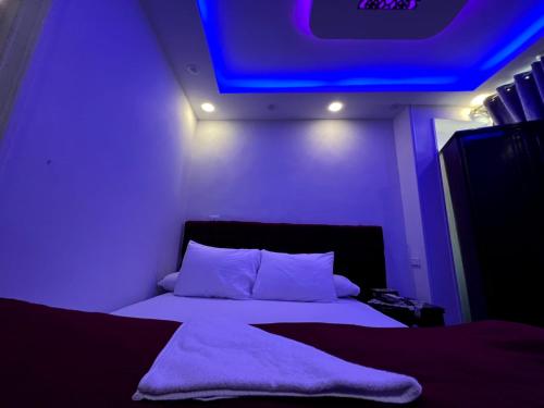 a bedroom with a bed with a blue light at Rost pyramids view in Cairo