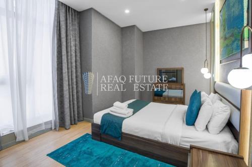 a bedroom with a bed with a blue rug at Vita Tower in Manama