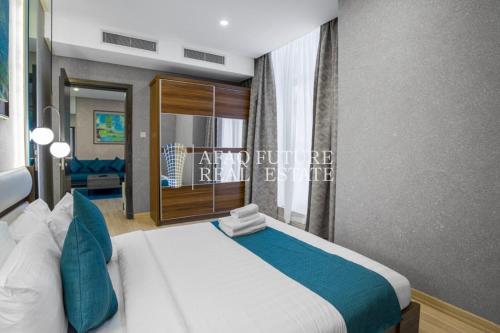 a bedroom with a large bed and a window at Vita Tower in Manama