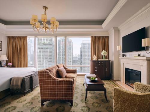 a hotel room with a bed and a fireplace at The Langham, Shenzhen in Shenzhen