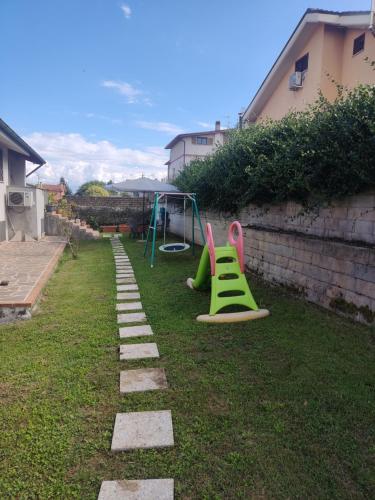 a backyard with a playground with a slide at La tana della Fenice in Labico