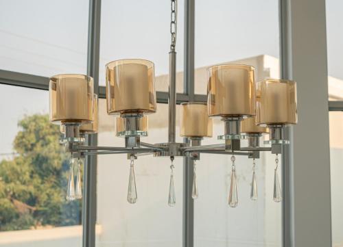 a chandelier hanging in a room with a window at Cassoma House in Luanda