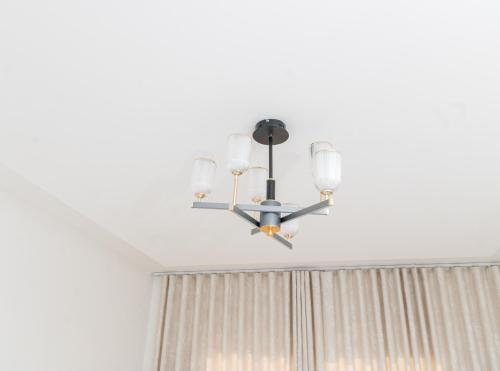 a black chandelier hanging from a ceiling at Cassoma House in Luanda