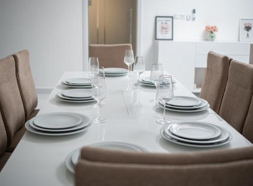 a dining room table with plates and wine glasses at Cassoma House in Luanda