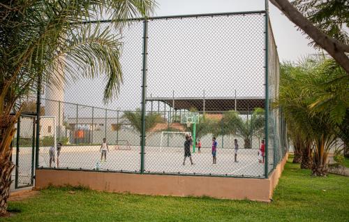 a group of children playing inside of a fence at Cassoma House in Luanda