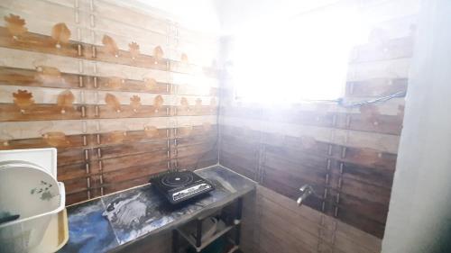 a bathroom with a sink and a stove in it at The Corner House by Liz Non Airconditioned in Mahabalipuram