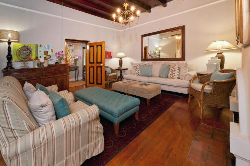 
a living room filled with furniture and a couch at De Doornkraal Vinotel in Riversdale
