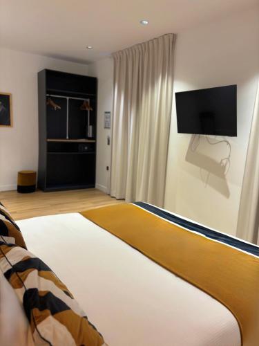 a bedroom with a bed and a flat screen tv at Star Champs-Elysées in Paris