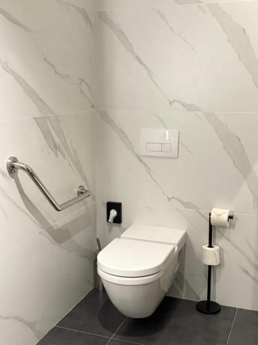 a white bathroom with a toilet and a wall at Star Champs-Elysées in Paris