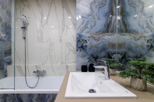 a bathroom with a sink and a shower at Новобудова Великобританія вул Шевченка 27 in Lviv