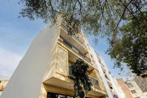 a white building with a window on the side of it at Collection O 24/7 Hotel in New Delhi