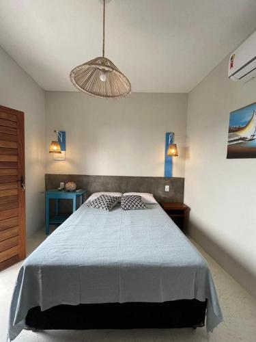 a bedroom with a large bed and a light fixture at Sunshine Kite Inn in Prea