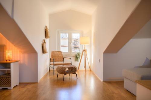 a living room with a chair at Atelier LAKOTA in Brtonigla